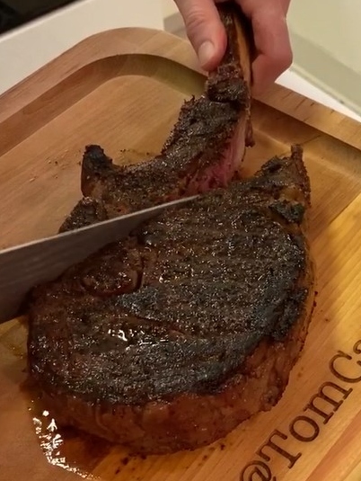 ribeye bone being sliced off the steak